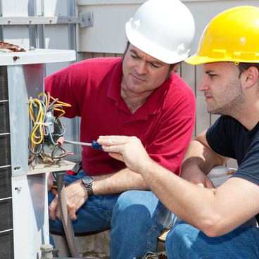 Our experts troubleshoot a heat pump on an HVAC unit outside a customer's home.